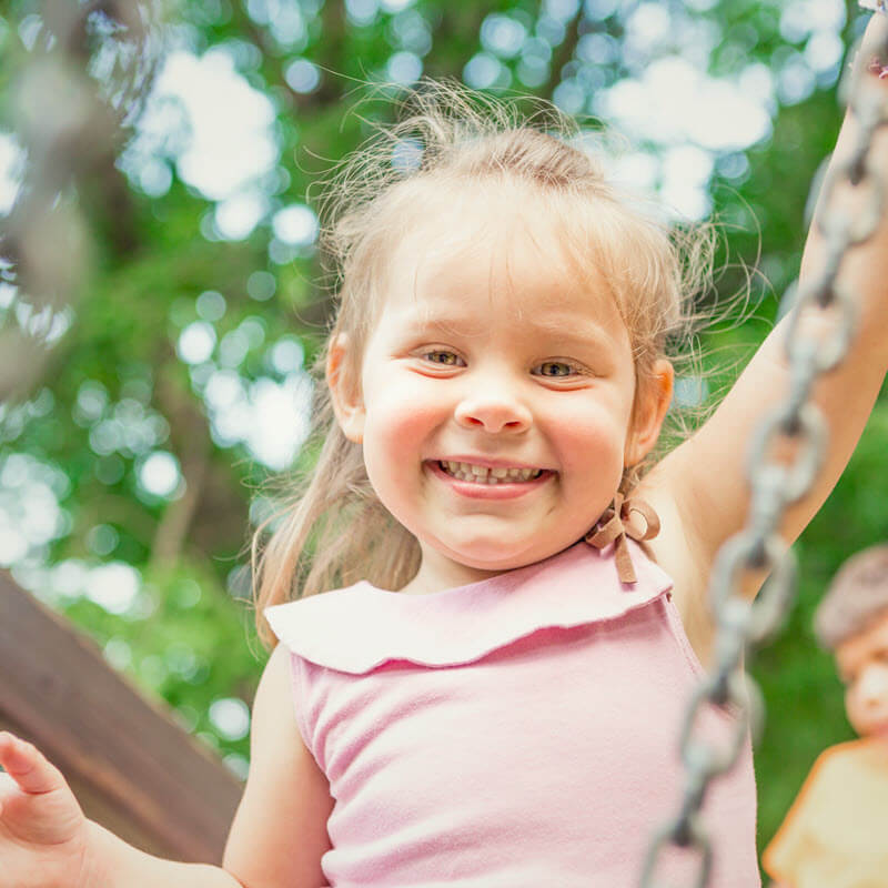 girl smiling on swing